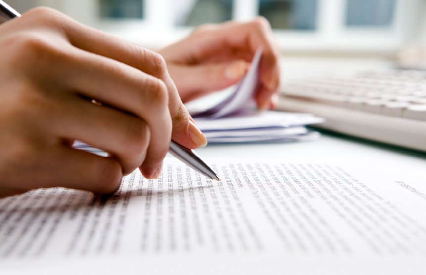 Close-up of secretarys hands doing paperwork